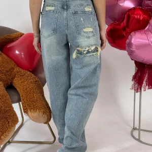 JEANS STRAPPO CON FIORI